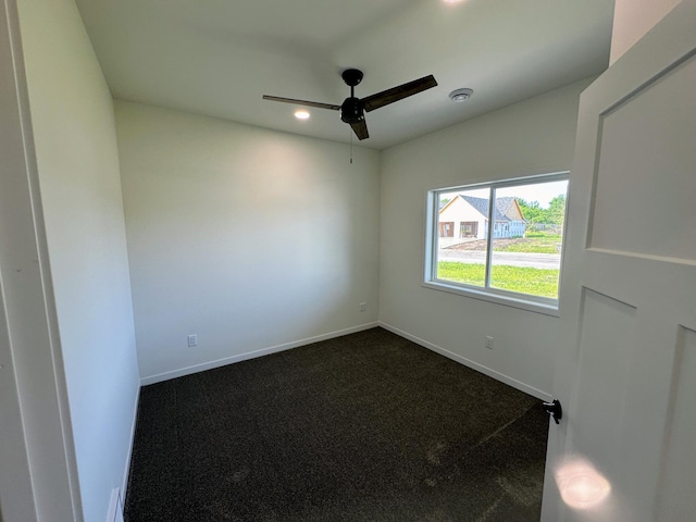 spare room featuring recessed lighting, dark colored carpet, baseboards, and a ceiling fan