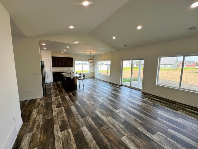 living room with dark wood-style flooring, baseboards, recessed lighting, and vaulted ceiling