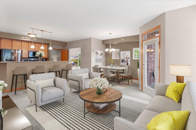 living room with plenty of natural light and a notable chandelier