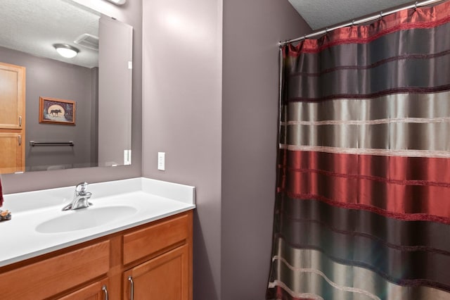 bathroom with vanity and a textured ceiling