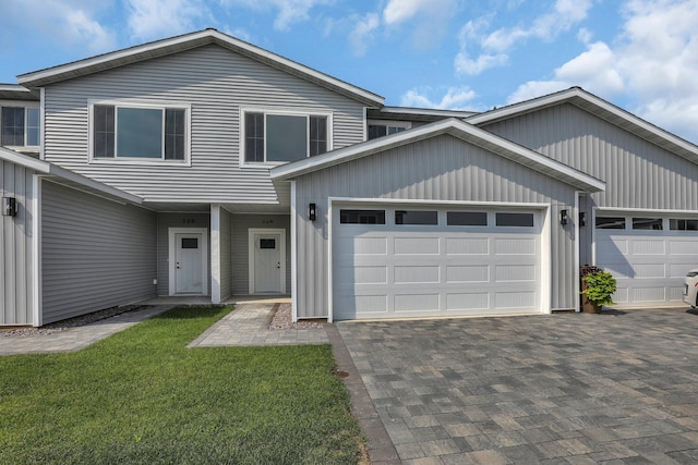 view of front of home with a garage and a front yard