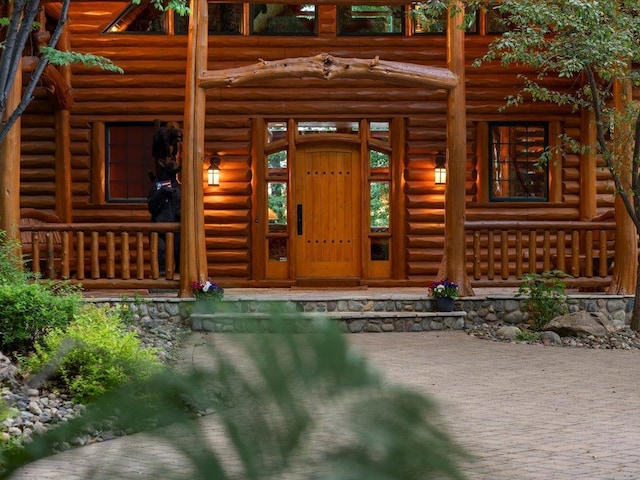 doorway to property featuring a porch