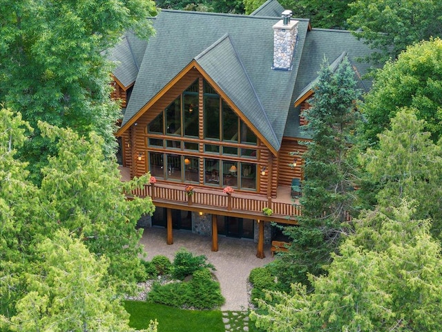 back of house featuring a wooden deck