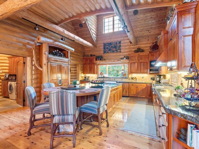 kitchen with beamed ceiling, high vaulted ceiling, log walls, and wood ceiling