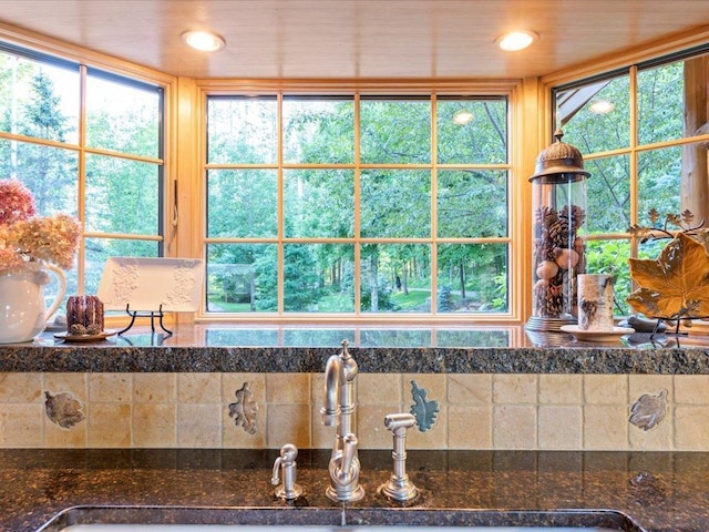 interior space with sink and dark stone counters