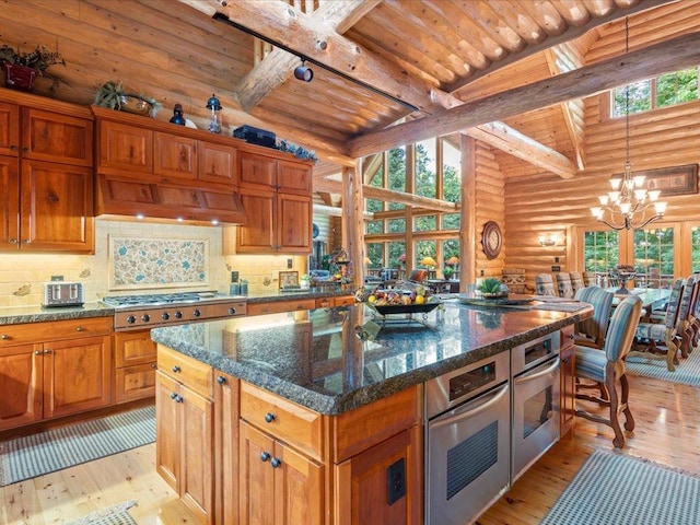 kitchen with wood ceiling, appliances with stainless steel finishes, a center island, decorative backsplash, and a chandelier