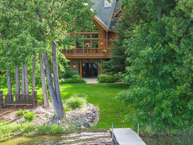 view of yard with a deck with water view