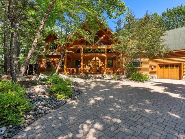 cabin with a porch and a garage