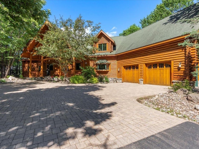 log-style house with a garage