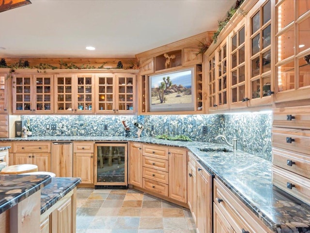 kitchen featuring wine cooler, sink, tasteful backsplash, and dark stone countertops