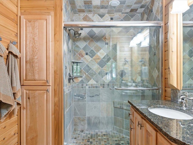 bathroom with vanity and a shower with shower door