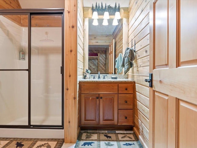 bathroom with a shower with door and vanity