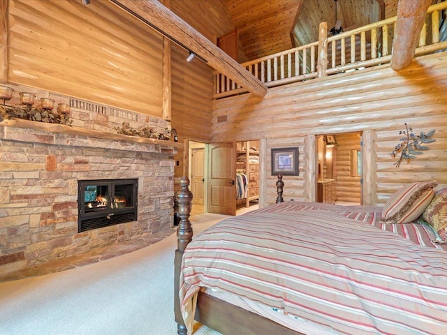 bedroom with log walls, a stone fireplace, high vaulted ceiling, and carpet flooring