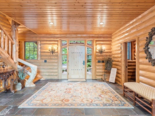 entryway with wooden ceiling and rustic walls