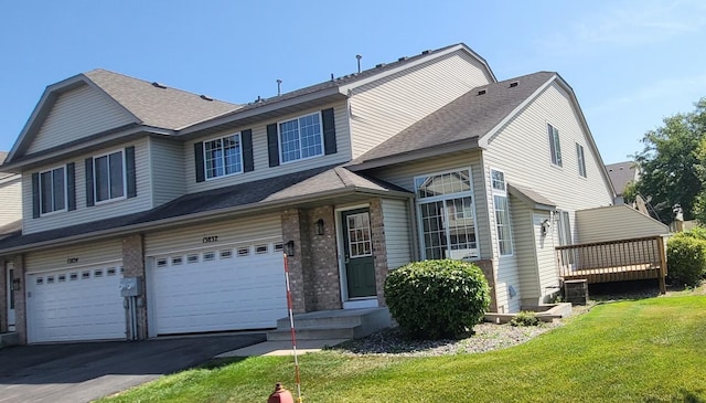 view of front of property with a front yard and a garage