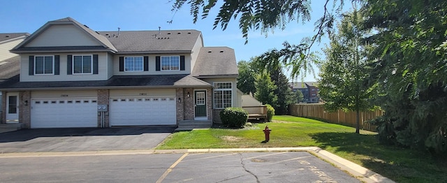 view of front of home with a garage and a front lawn