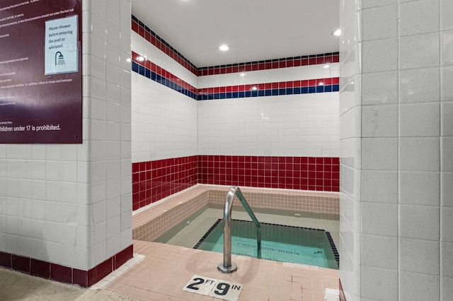 view of pool with an indoor hot tub