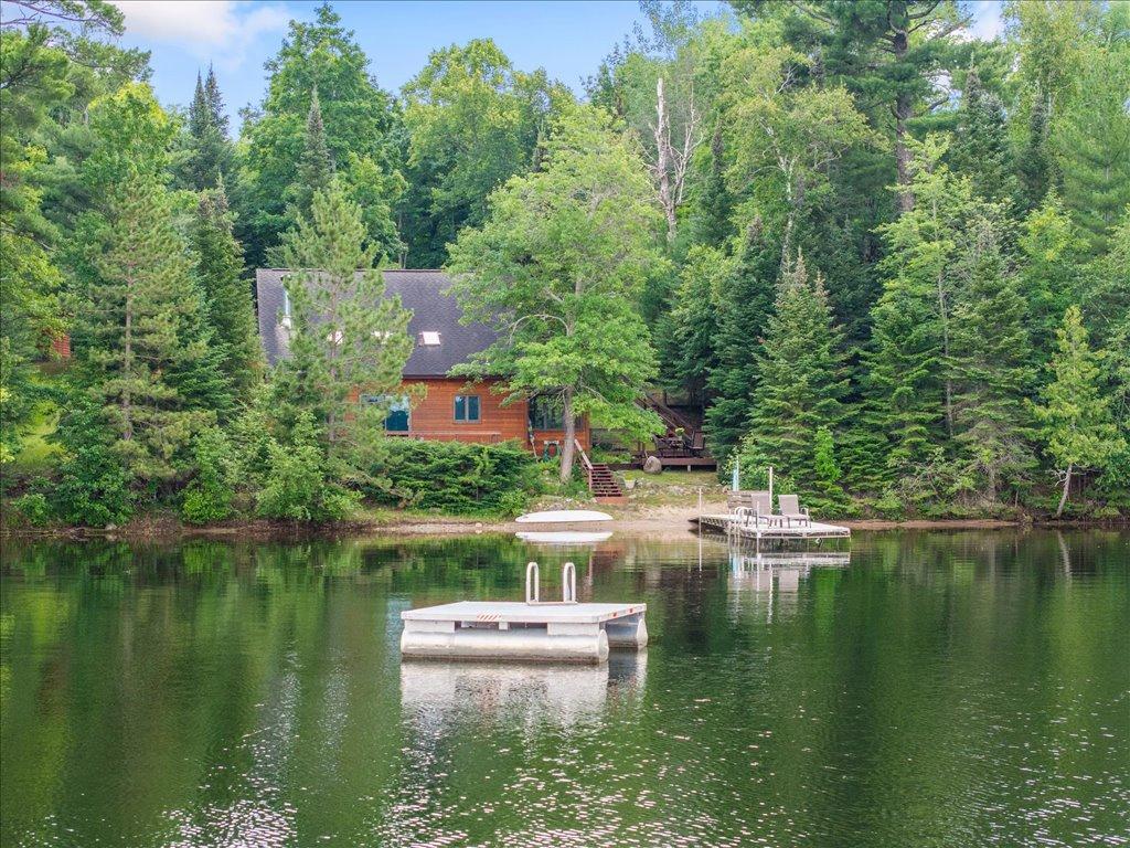 2220 Peninsula Rd NE, Outing, MN 56662 - water view with a floating dock and a view of trees