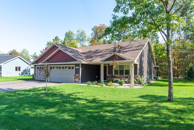 view of front of property with a front yard and a garage