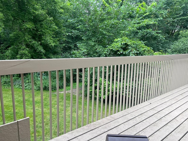 wooden deck featuring a yard