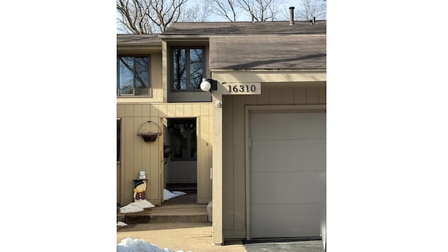 view of exterior entry with a garage