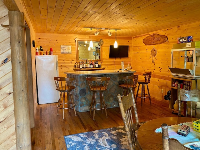 kitchen with wood ceiling, rail lighting, white fridge, and hardwood / wood-style flooring