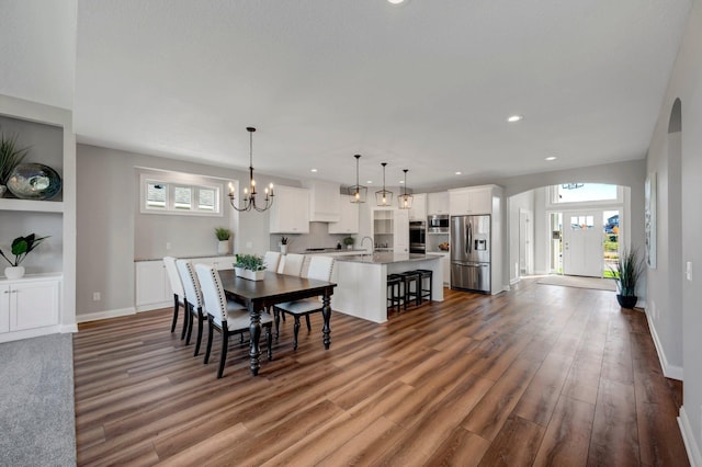 dining space featuring an inviting chandelier and dark wood-type flooring