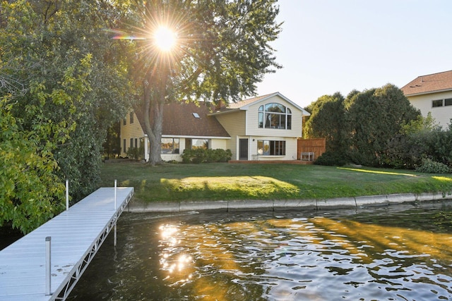 exterior space featuring a water view and a lawn