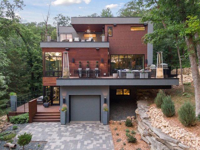 view of front of property featuring a balcony and a garage