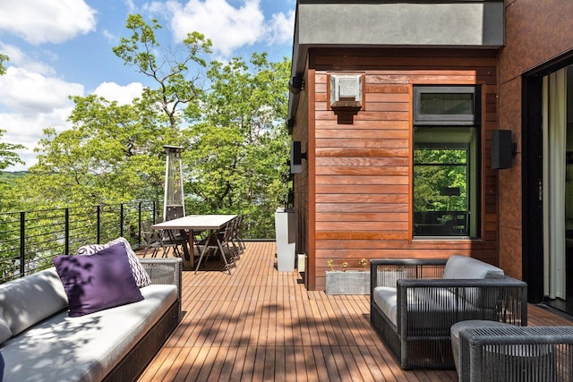 wooden terrace with outdoor lounge area