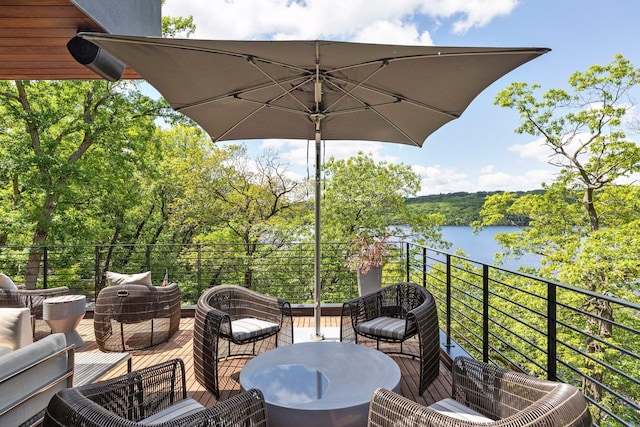 wooden terrace featuring outdoor lounge area and a water view