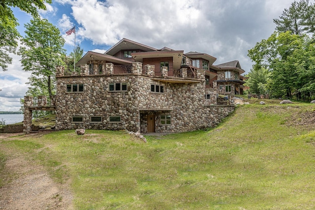 back of property featuring a yard and a balcony