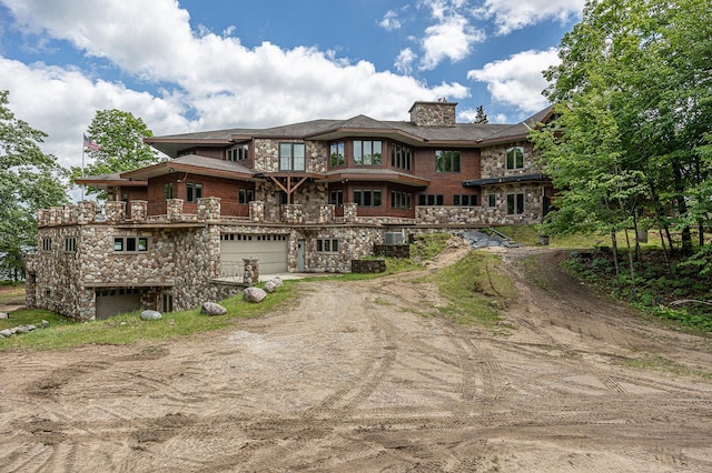 rear view of property featuring a garage