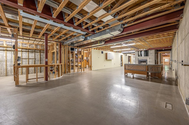 basement featuring a brick fireplace