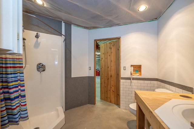 bathroom with concrete flooring, vanity, a shower with curtain, and toilet