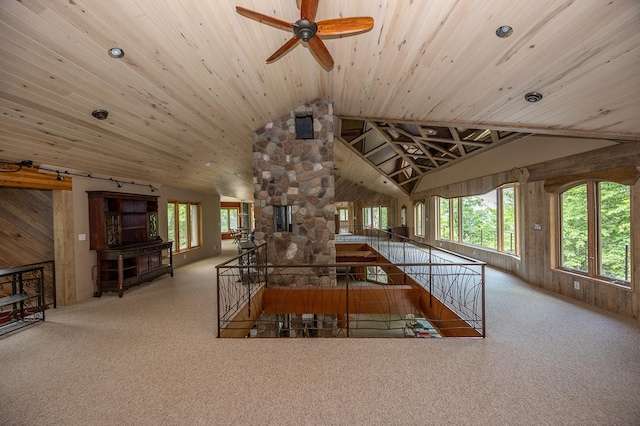 unfurnished living room featuring high vaulted ceiling, light colored carpet, plenty of natural light, and wood ceiling