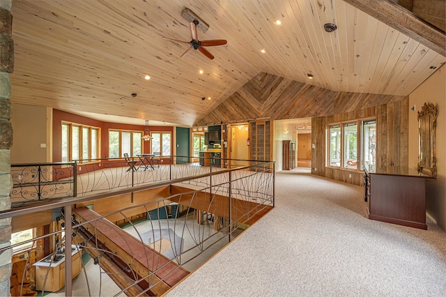 hall with vaulted ceiling, wooden ceiling, and light colored carpet