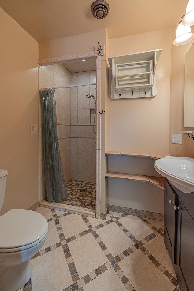 bathroom featuring toilet, vanity, and walk in shower