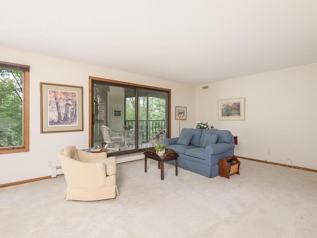 living room featuring a baseboard radiator and light colored carpet