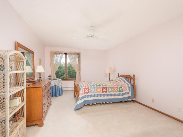 bedroom featuring a ceiling fan, light colored carpet, baseboards, and a baseboard radiator