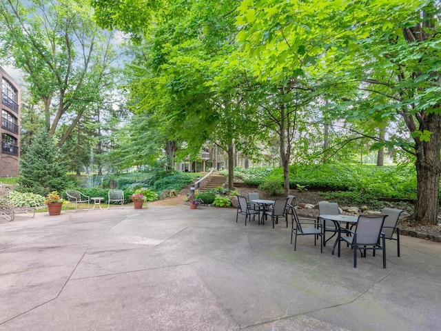 view of patio / terrace featuring outdoor dining space and stairs