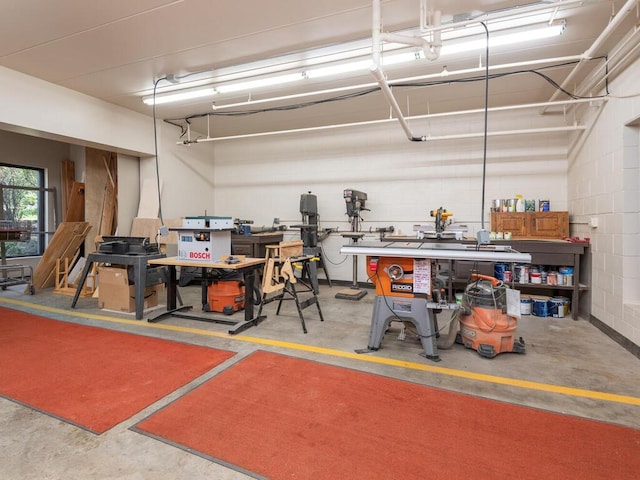 garage featuring a workshop area and concrete block wall