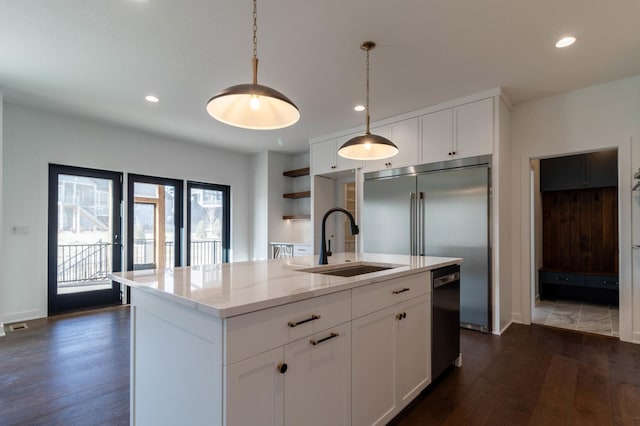 kitchen featuring sink, pendant lighting, a center island with sink, white cabinets, and dark hardwood / wood-style floors