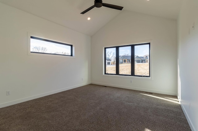 unfurnished room with dark colored carpet, ceiling fan, and high vaulted ceiling