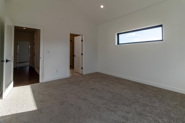 unfurnished bedroom with dark colored carpet