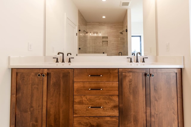 bathroom with vanity and a shower with shower door