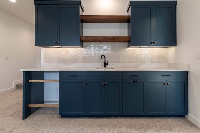 kitchen featuring blue cabinetry and light colored carpet