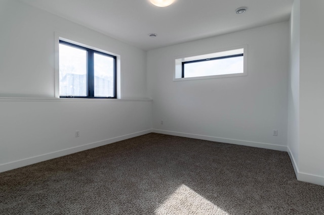 carpeted empty room featuring plenty of natural light