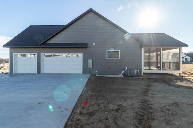 view of home's exterior featuring a garage and central AC