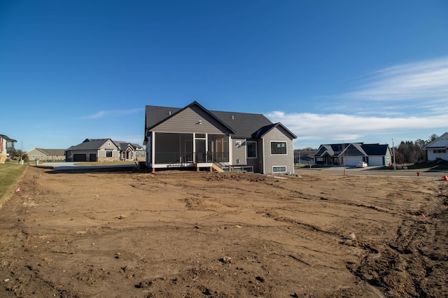 back of property featuring a sunroom